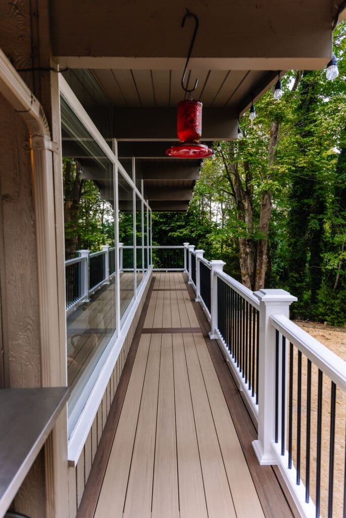 Vertical surface mount black post white rail composite railing