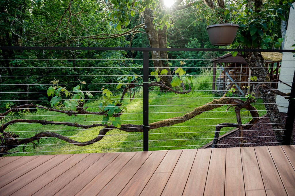 Brown composite decking with matte black fascia mounted cable railing