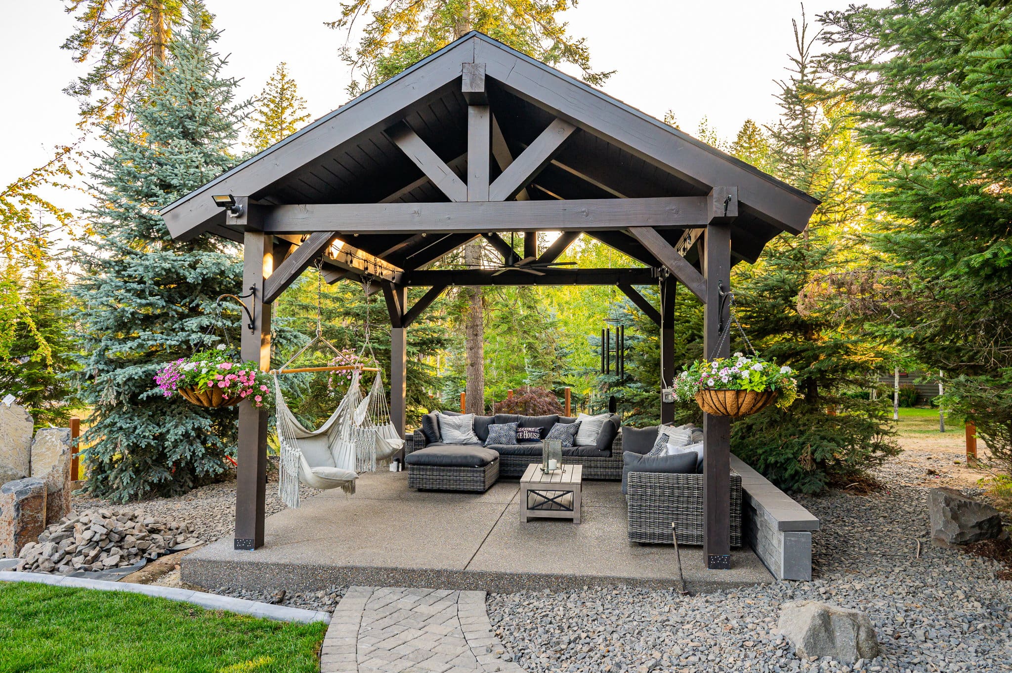 Solid roof patio cover providing full shade over a backyard deck with outdoor seating