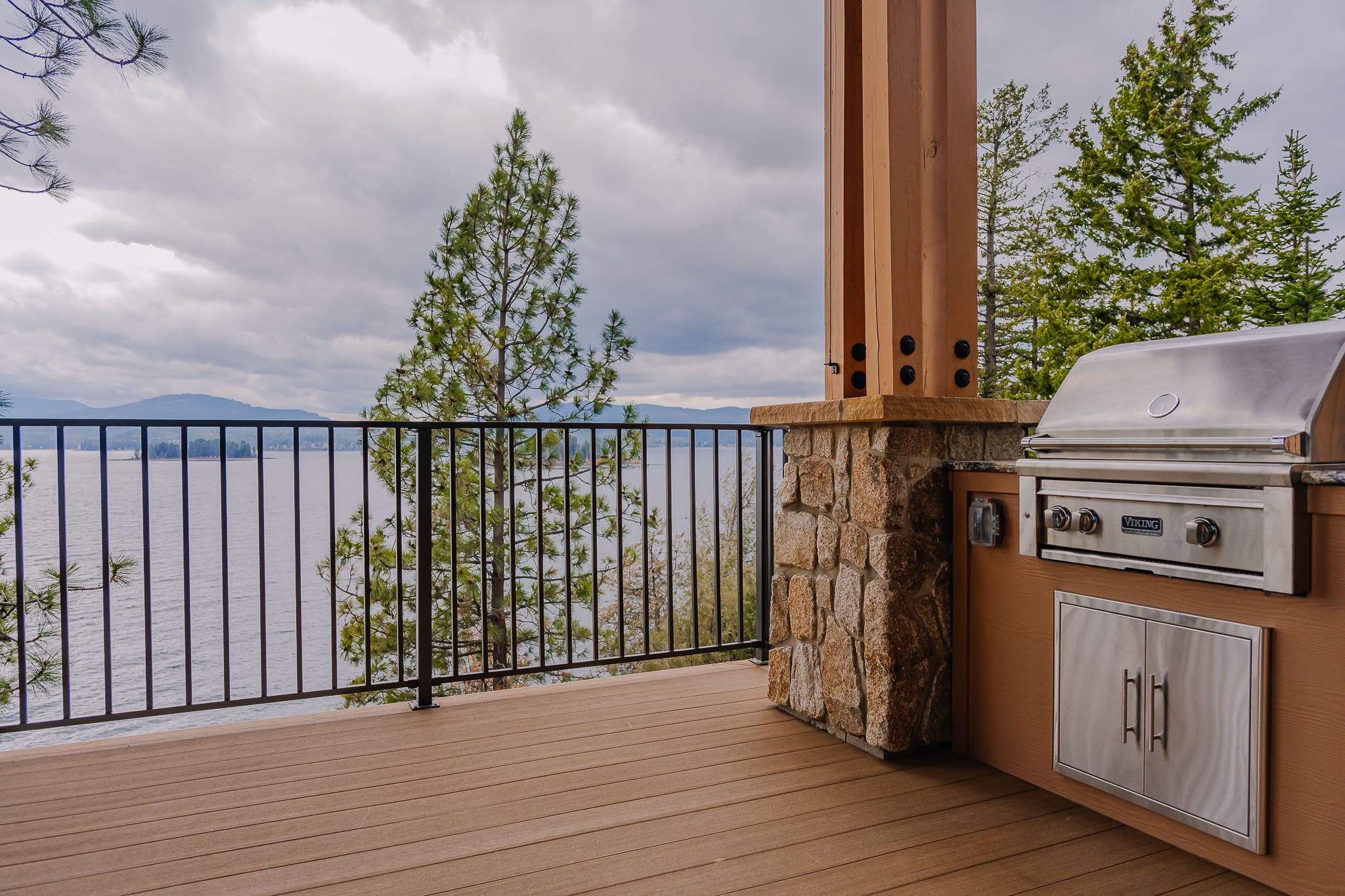 Outdoor grill on lakefront deck.