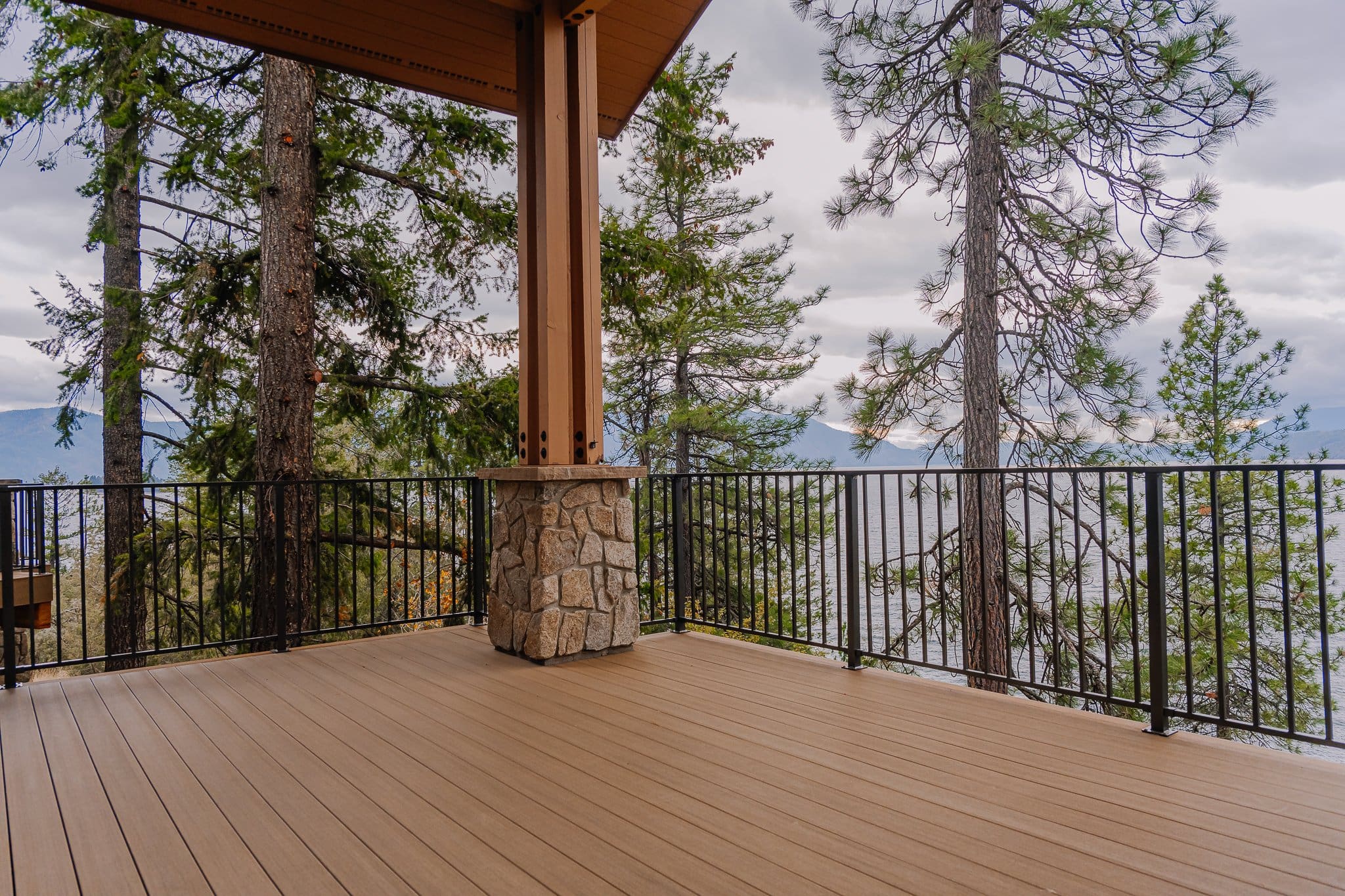 Scenic weathered teak deck with forest and lake view