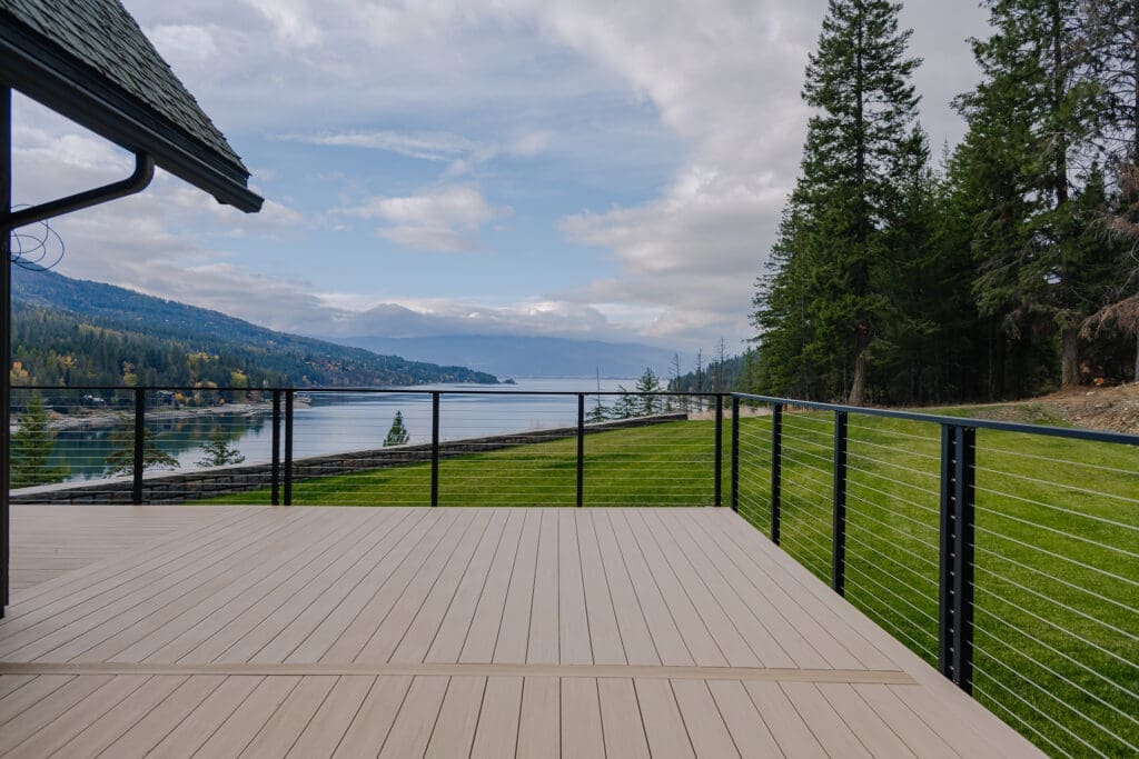 Lake view from composite deck, surrounded by trees.
