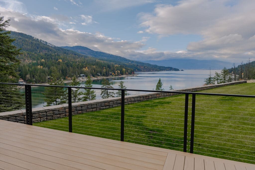 Mountain lake view from balcony with railing.
