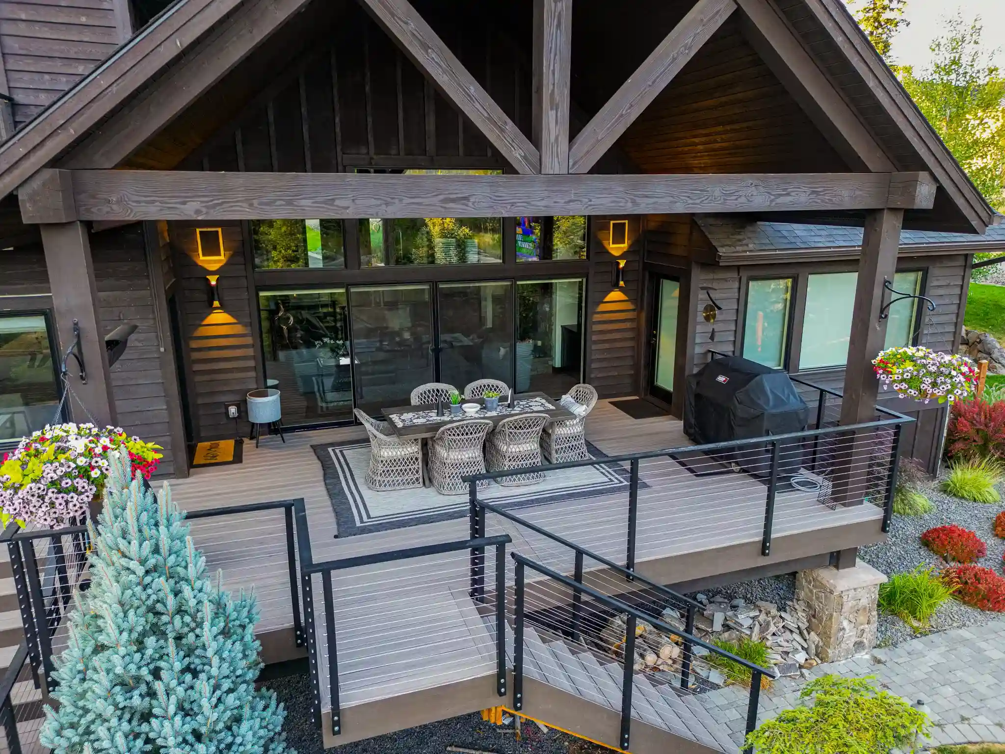 Modern wooden deck with seating and grill area.