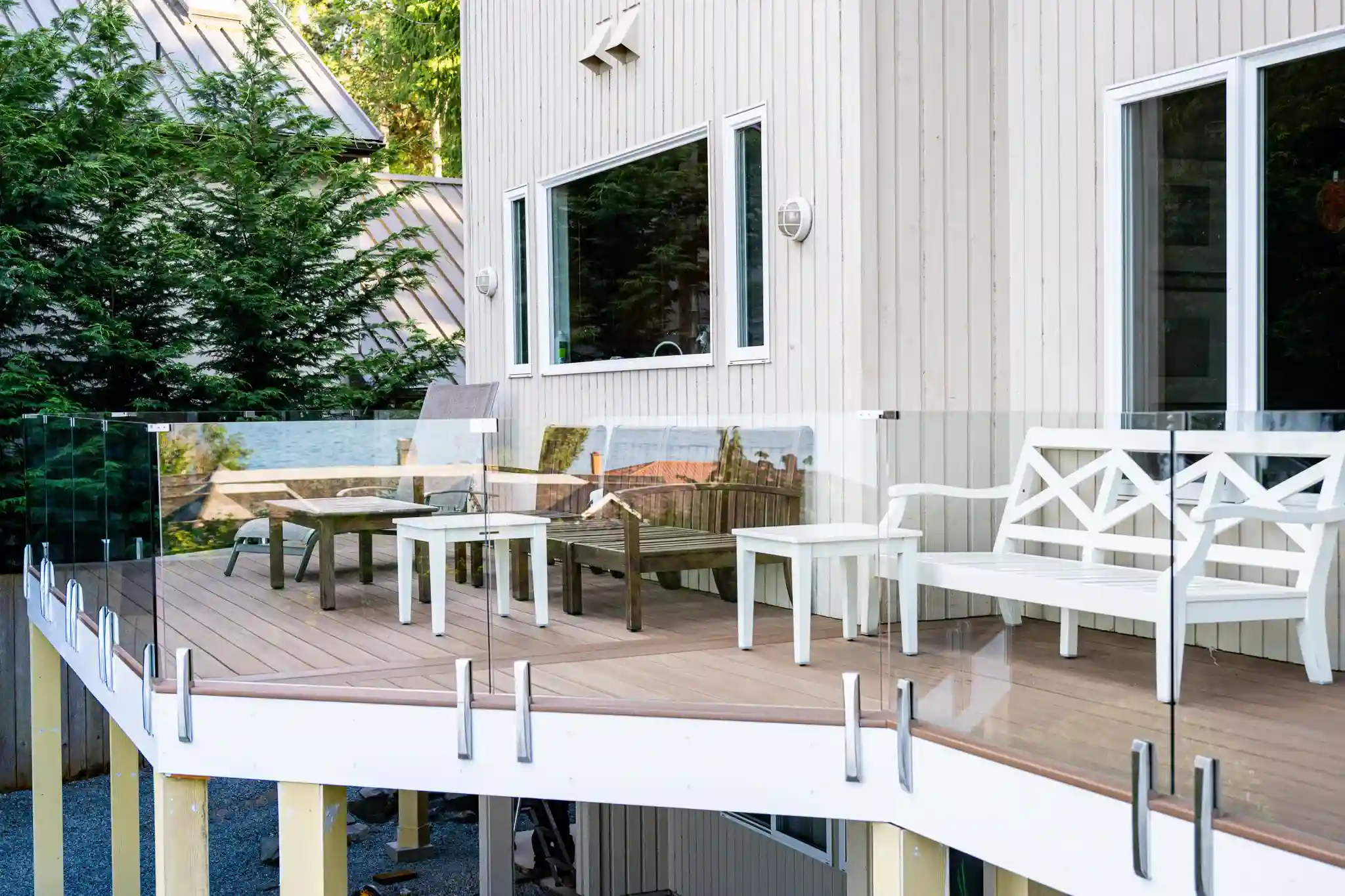 Modern patio with glass railing and white furniture