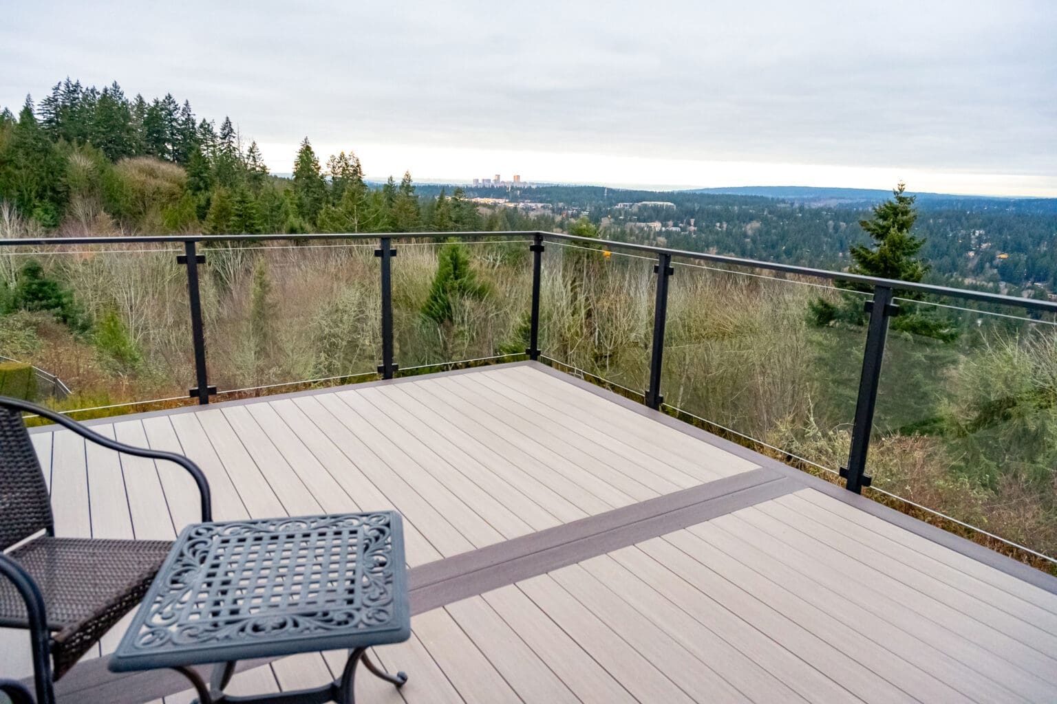 Scenic view from modern deck overlooking forest landscape.
