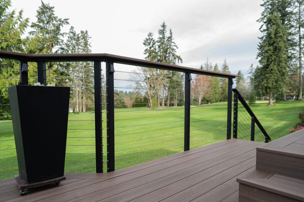 Deck view overlooking green lawn and trees