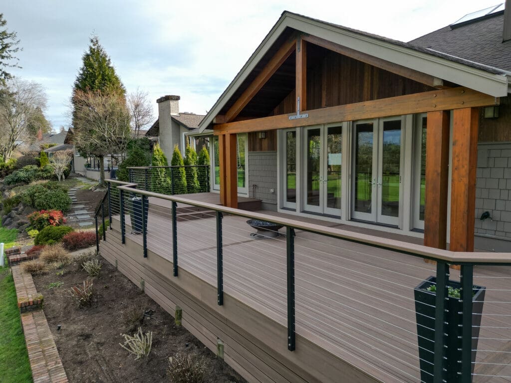 Wooden deck overlooking garden and landscape.