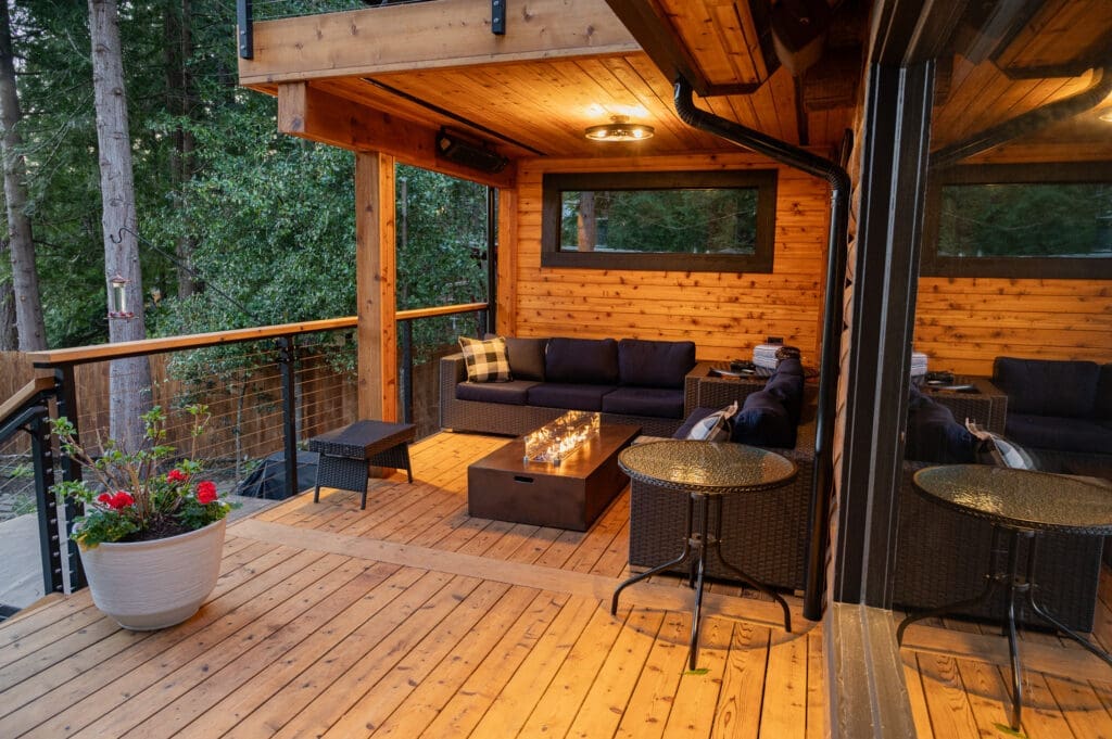 Cozy wooden deck with outdoor furniture and fire pit.
