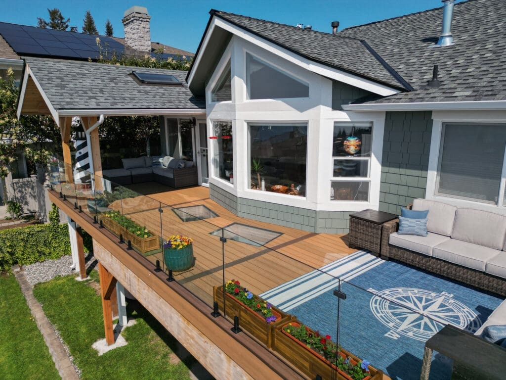 Modern house with solar panels and outdoor seating area.
