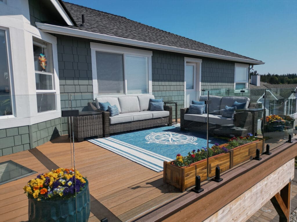 Cozy outdoor patio with wicker furniture and flowers.