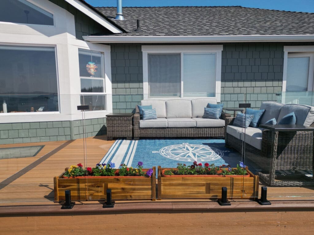 Cozy patio with wicker furniture and flower boxes.
