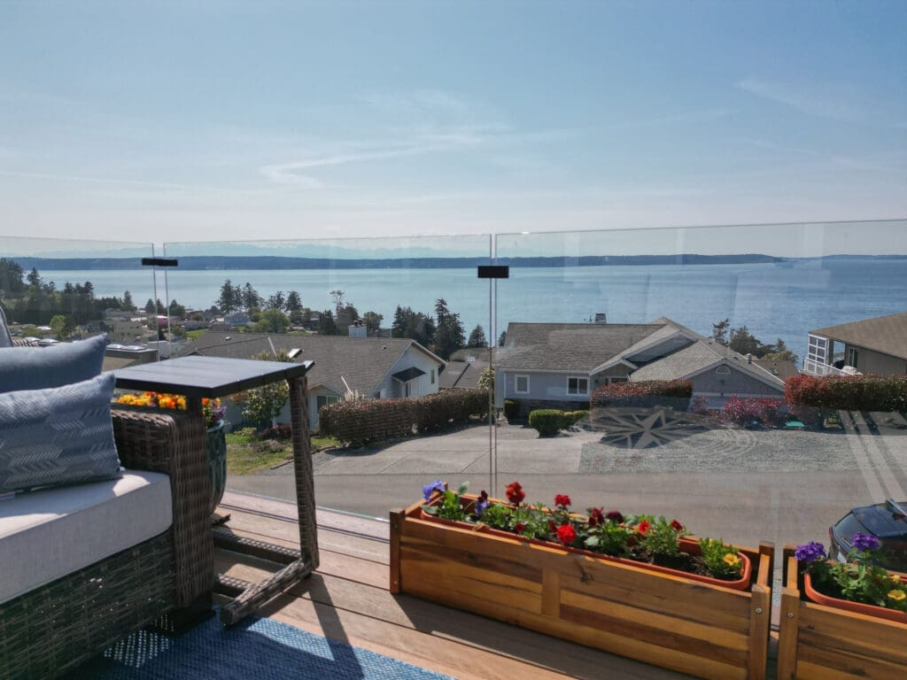 Scenic ocean view from rooftop patio with flowers.