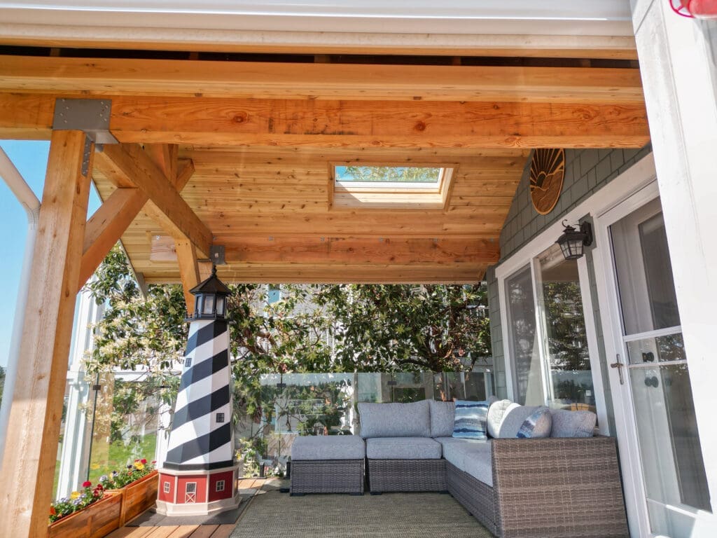 Cozy porch with seating and lighthouse decoration.