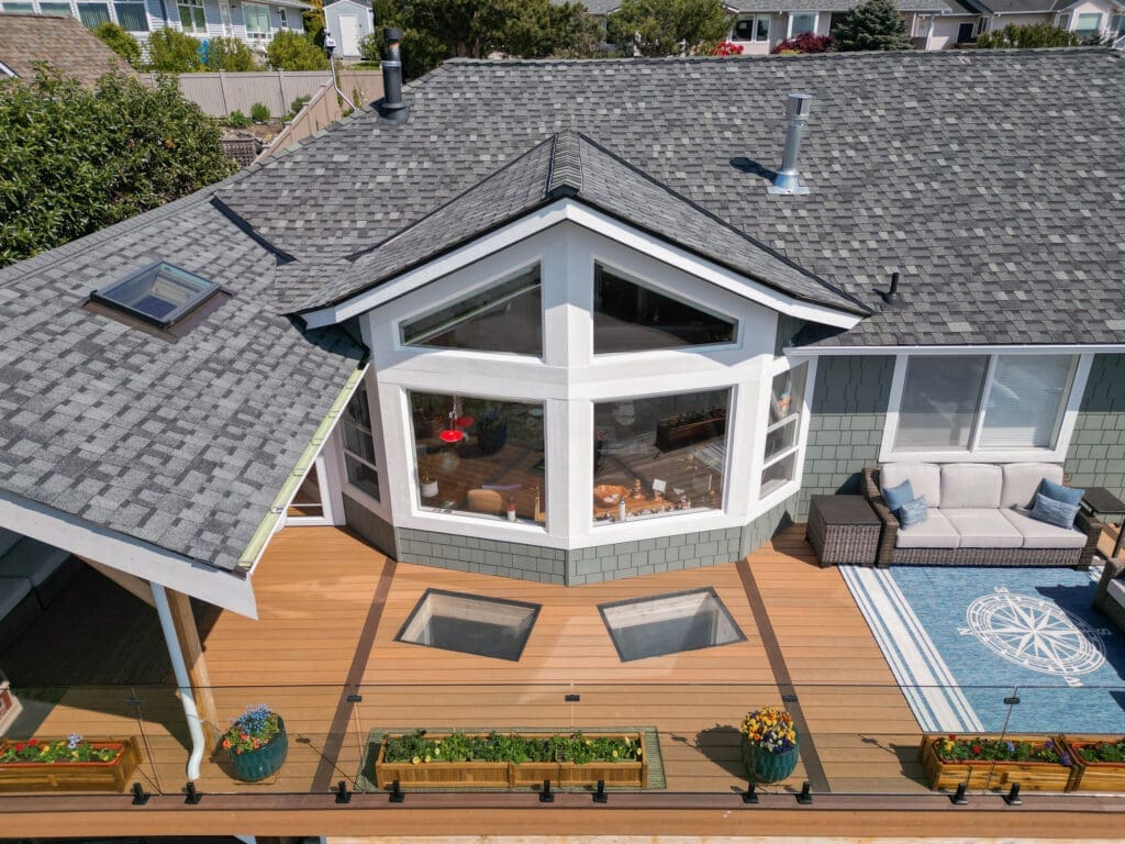 Aerial view of modern house with deck and seating.