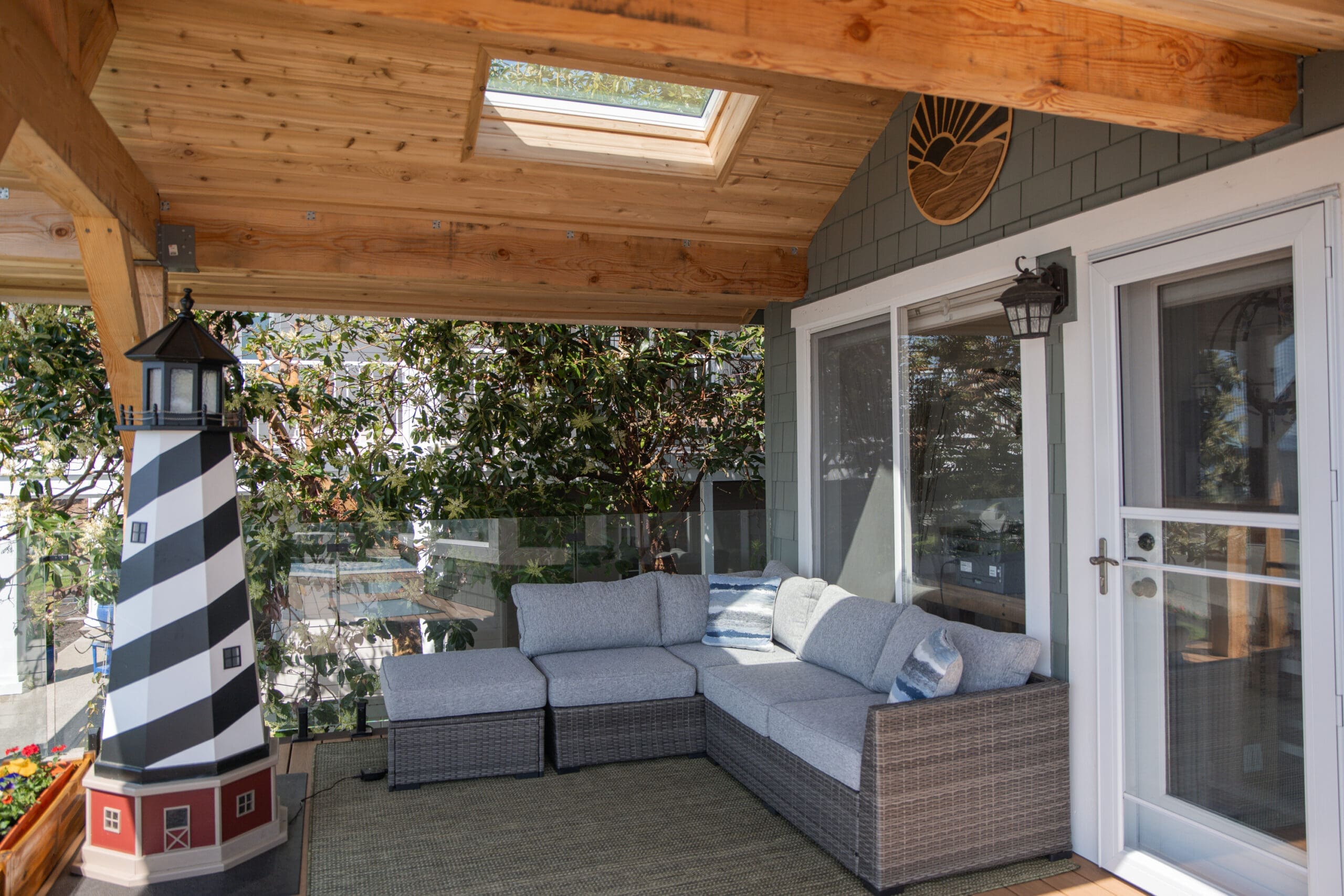 Cozy patio with sofa and lighthouse decor.