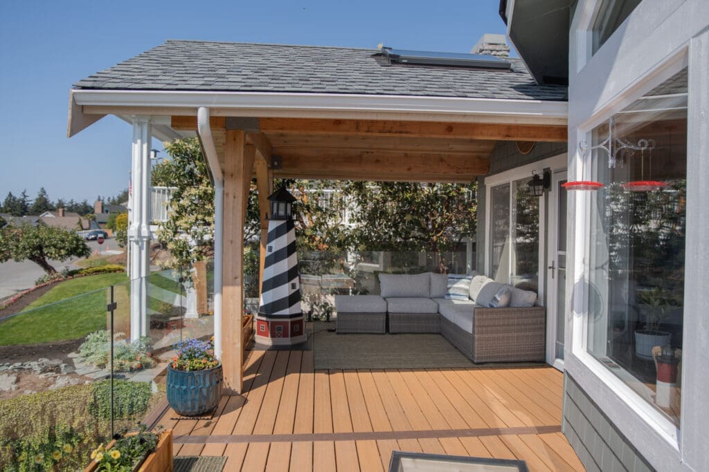 Cozy outdoor patio with seating and lighthouse decor.