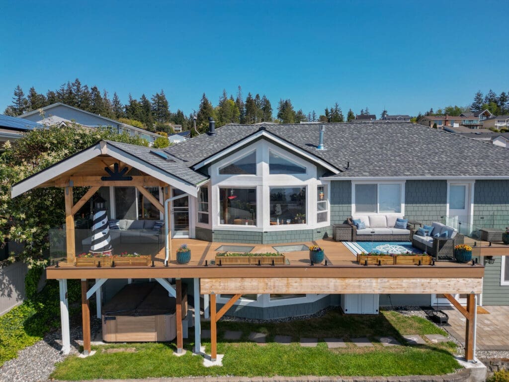 Modern house with spacious deck and lush landscape