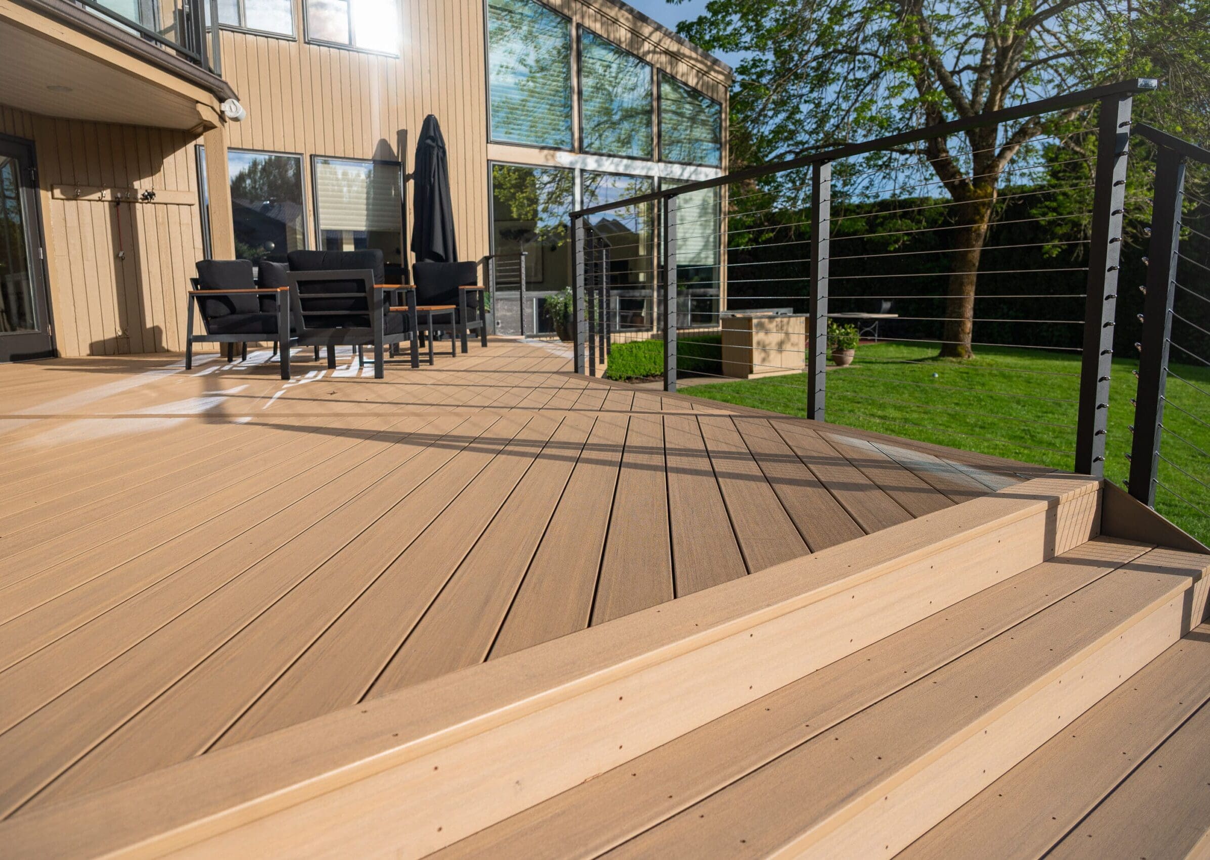 Spacious timbertech deck with outdoor furniture.