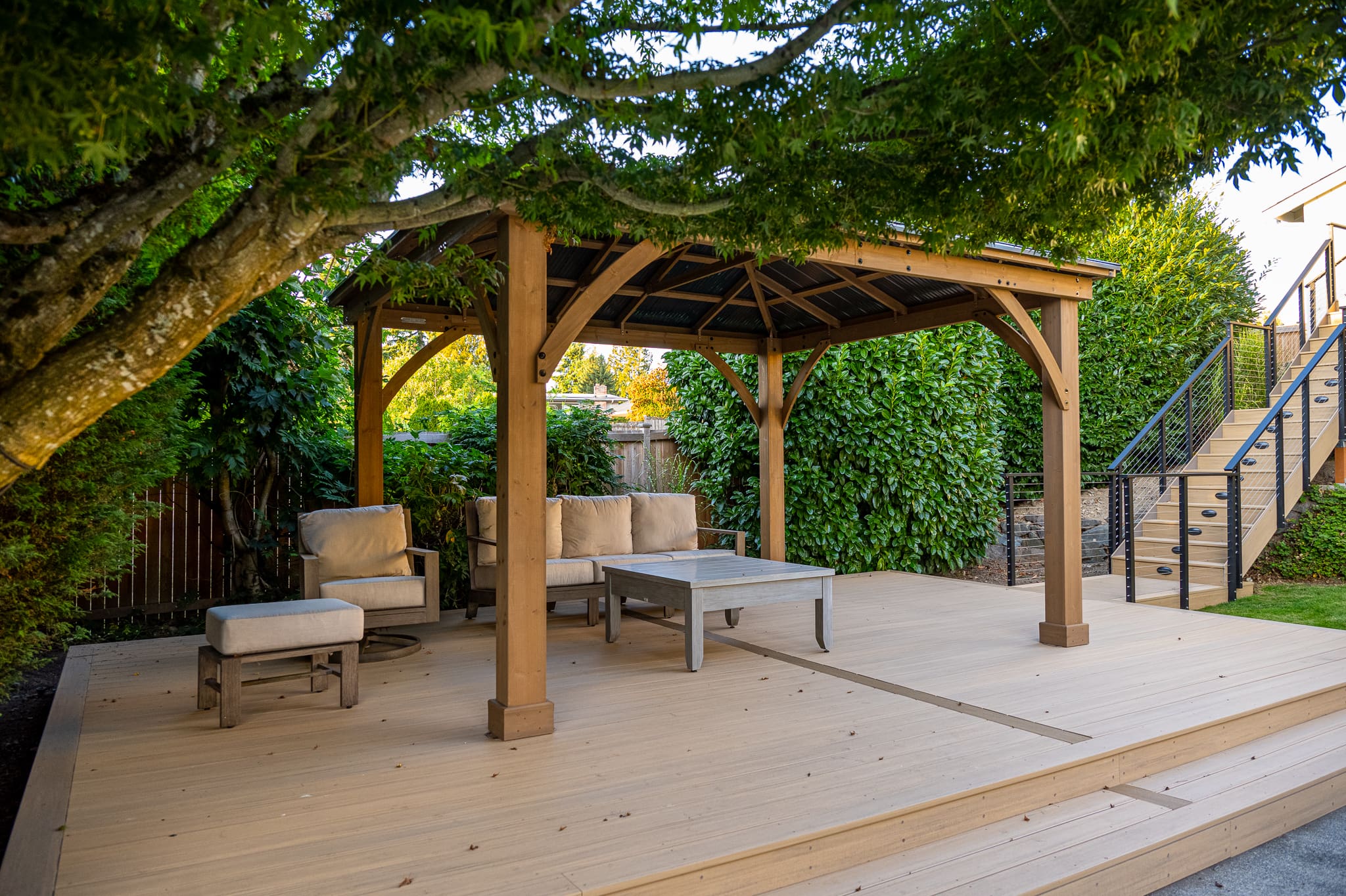 Outdoor wooden pergola with seating on deck