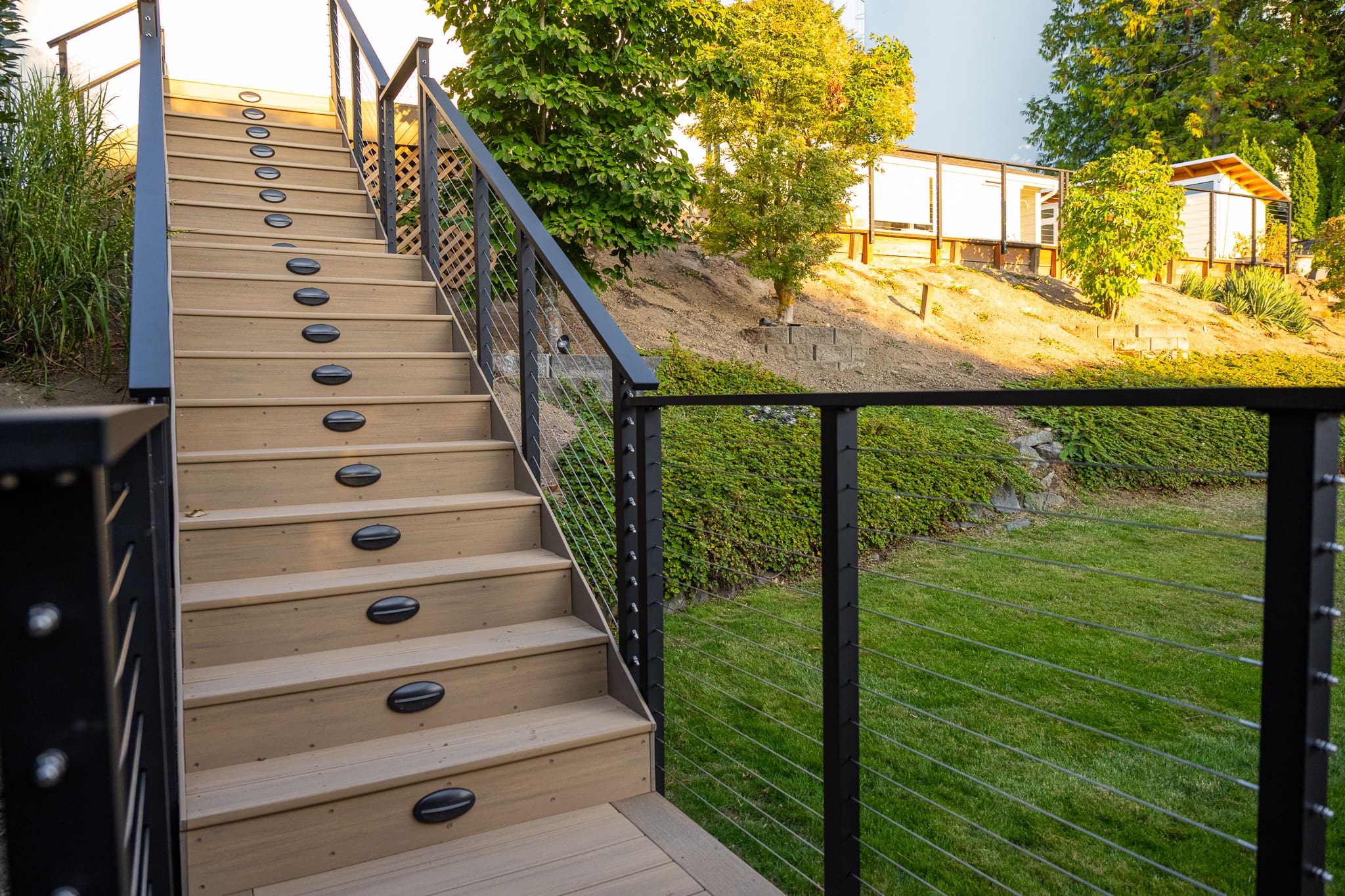 Outdoor staircase with metal railings and greenery