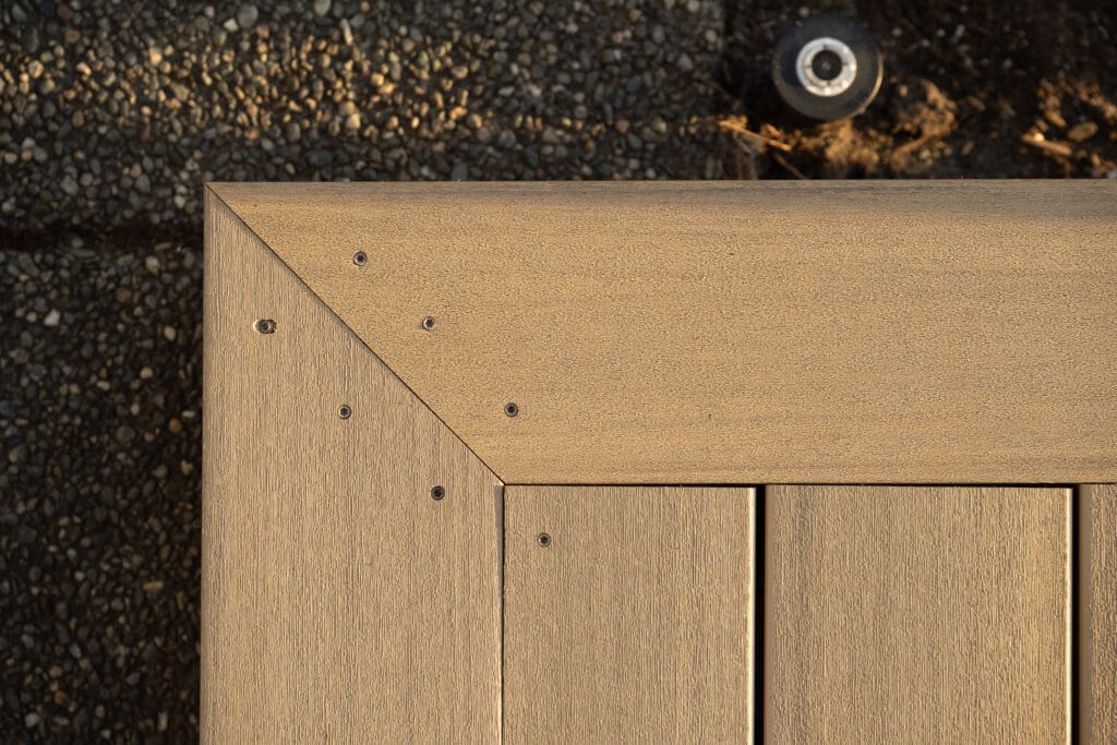 Close-up of deck corner with screws and texture.
