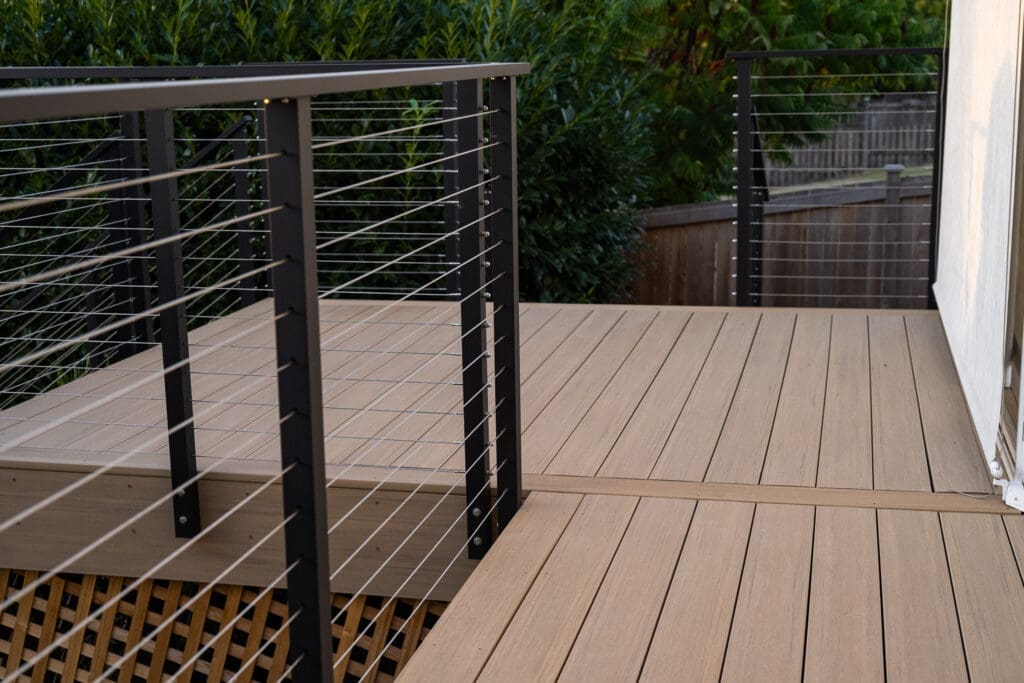 Modern wooden deck with cable railing design.