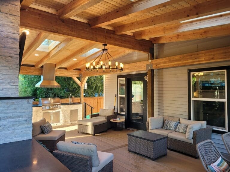 Covered patio with seating and outdoor kitchen.