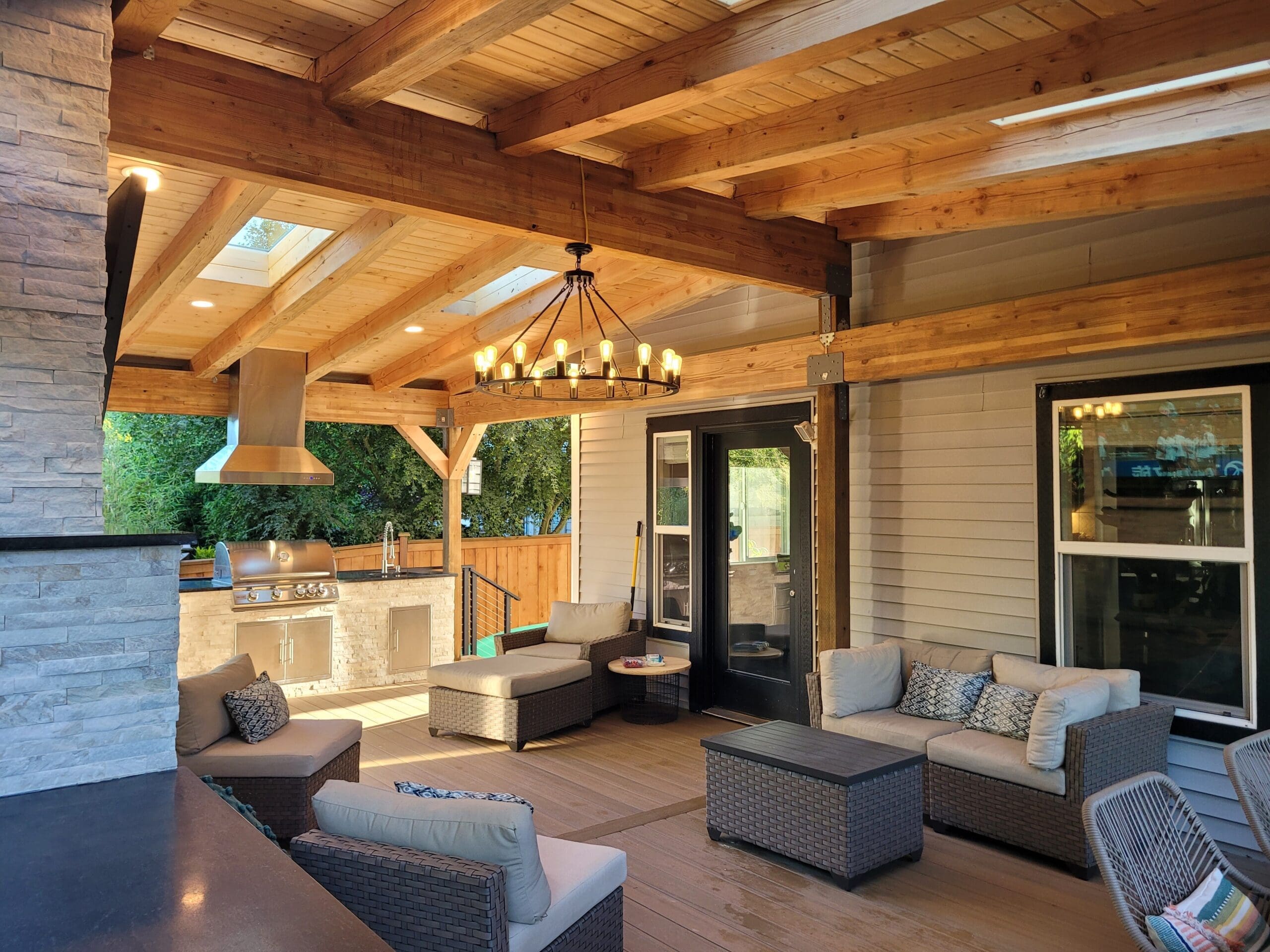 Covered patio with seating and outdoor kitchen.