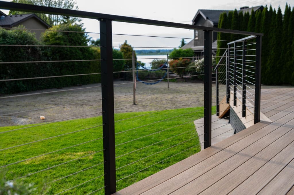 Modern deck with cable railing overlooking backyard
