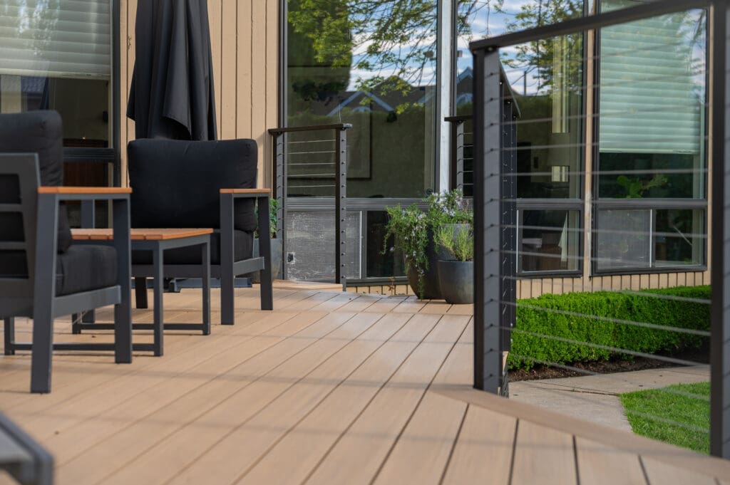 Modern wooden deck with black patio chairs