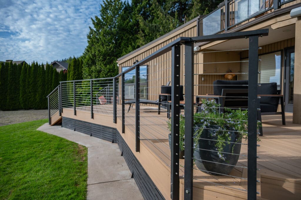 Modern wooden deck with black metal railing