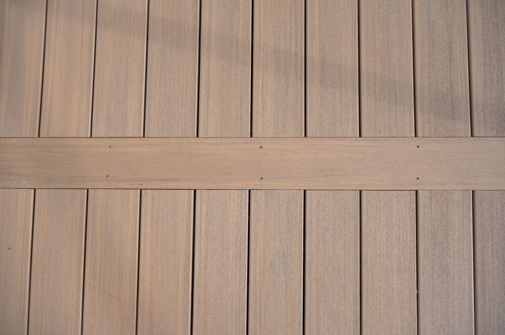 Vertical wooden deck boards with horizontal plank