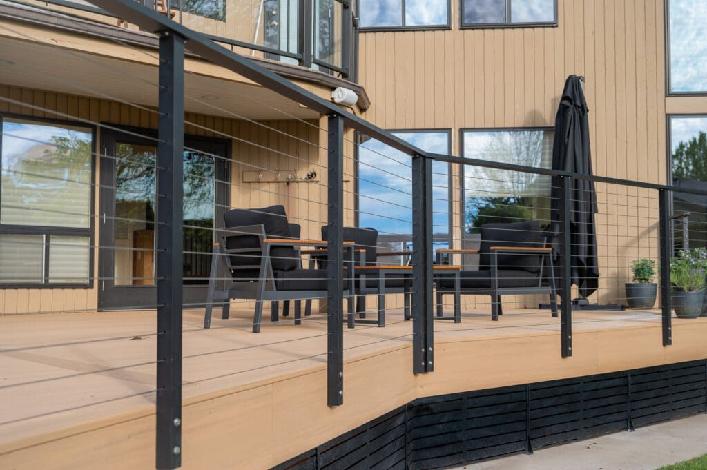 Modern wooden deck with black metal railing