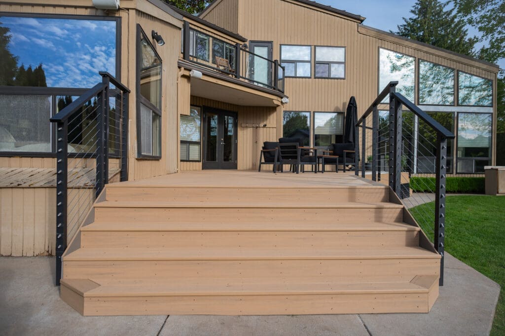 Modern wooden deck with black metal railings