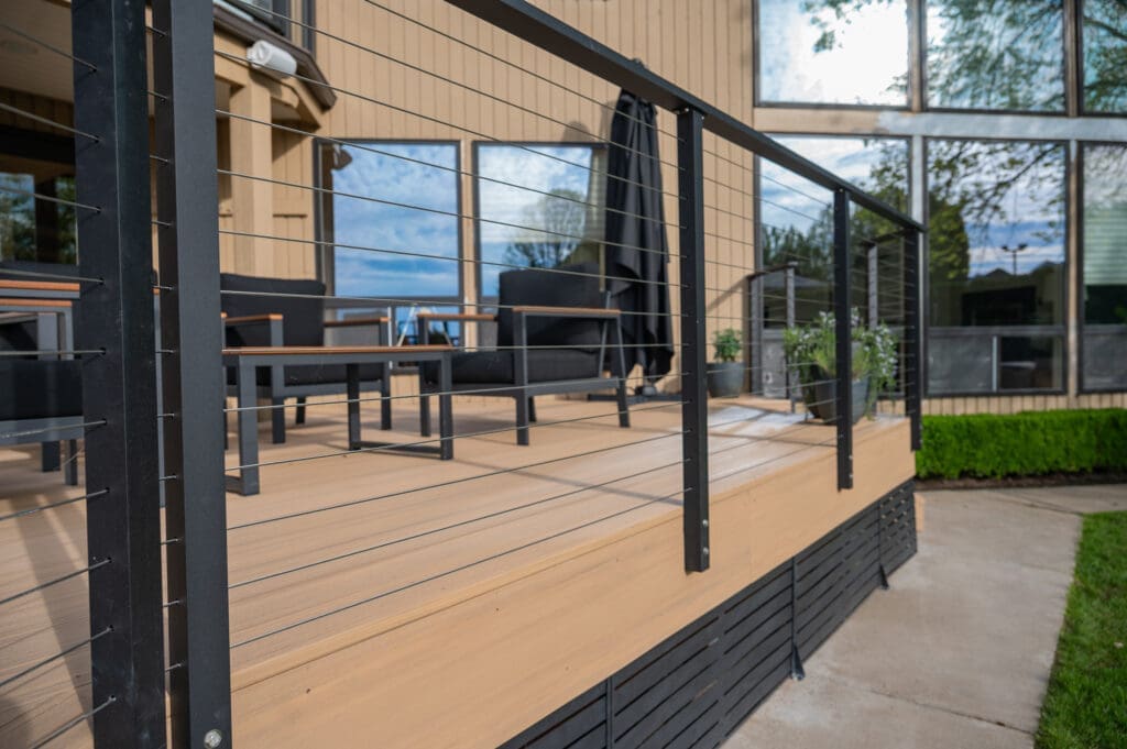 Modern wooden deck with black cable railing