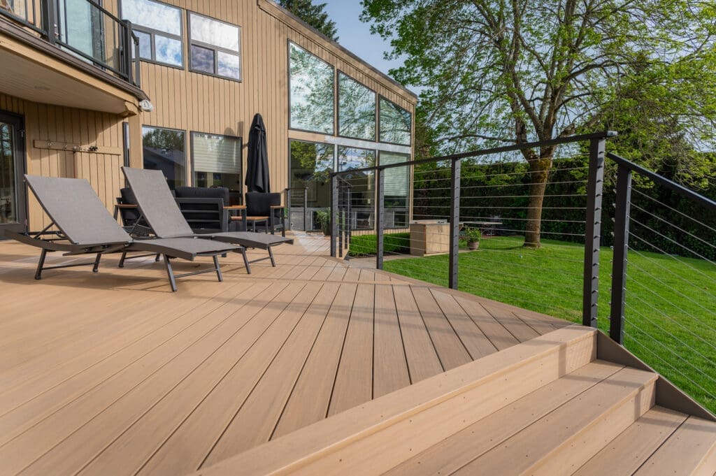 Modern wooden deck with lounge chairs and railing
