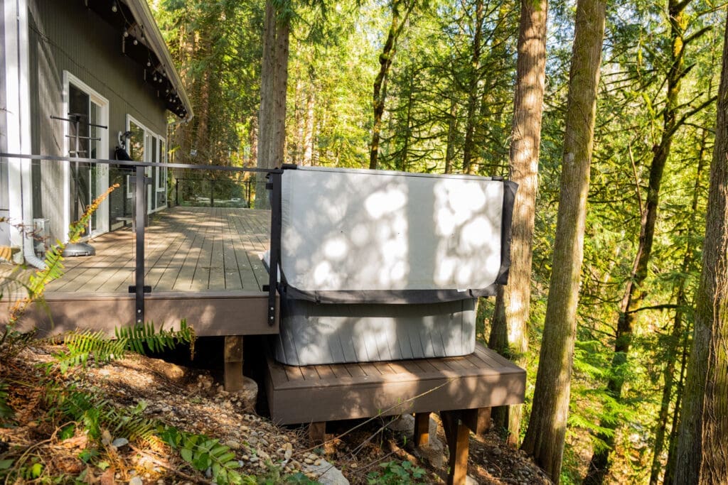 Forest cabin deck with outdoor hot tub