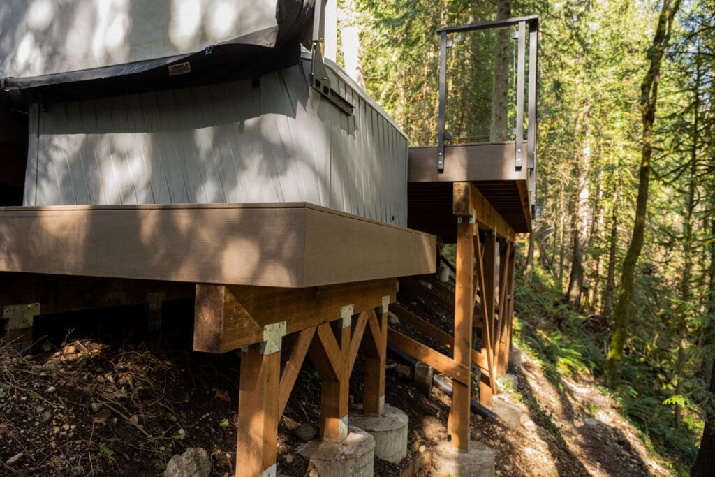Elevated deck structure in forest on wooden stilts
