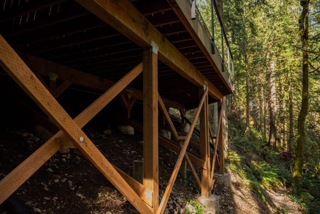 Wooden deck supports on forest hillside slope