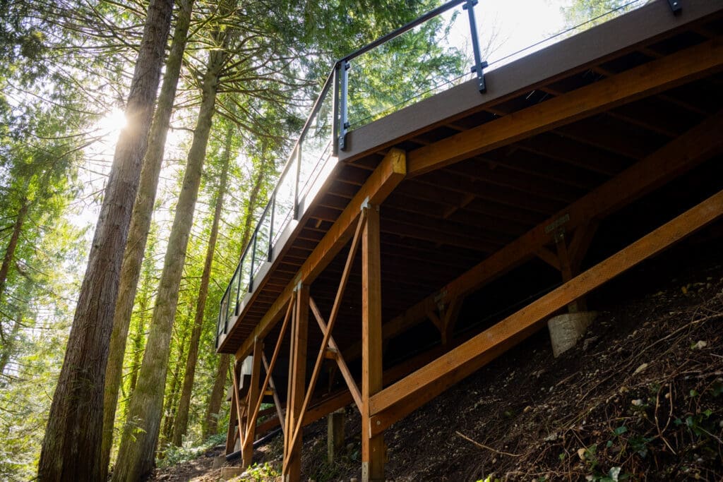 Elevated wooden deck on forested hillside