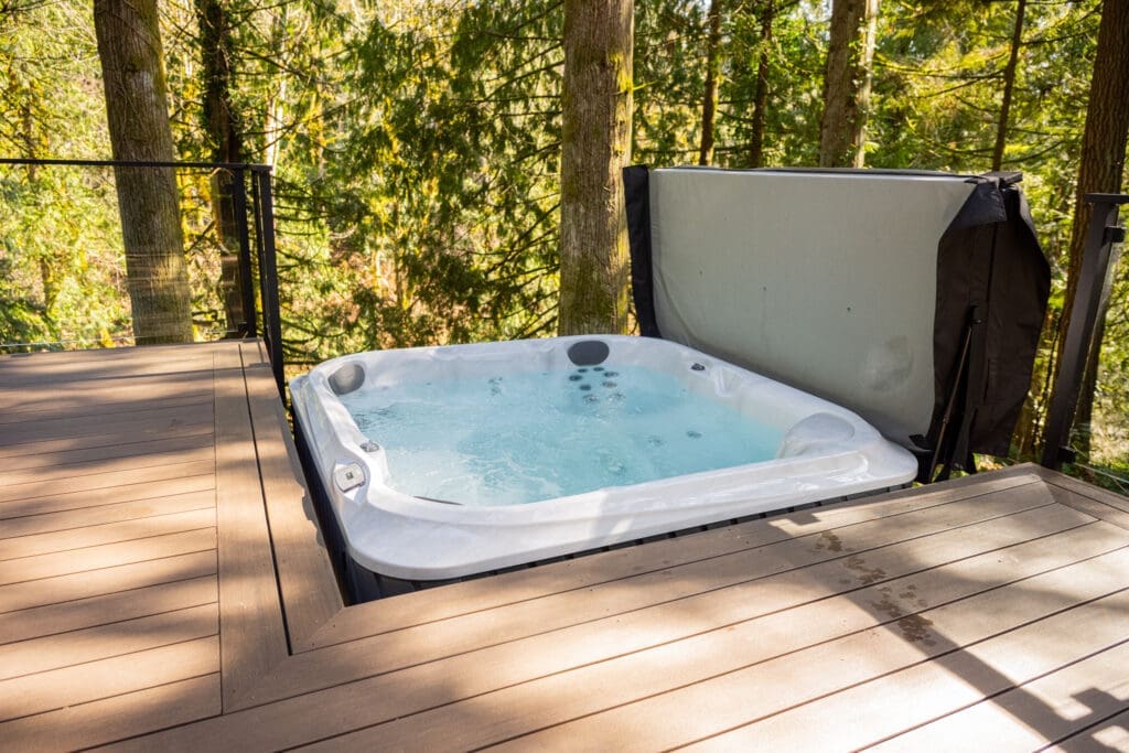 Outdoor hot tub on forest deck