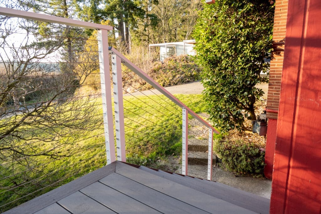 Small deck with cable railing overlooking grassy yard