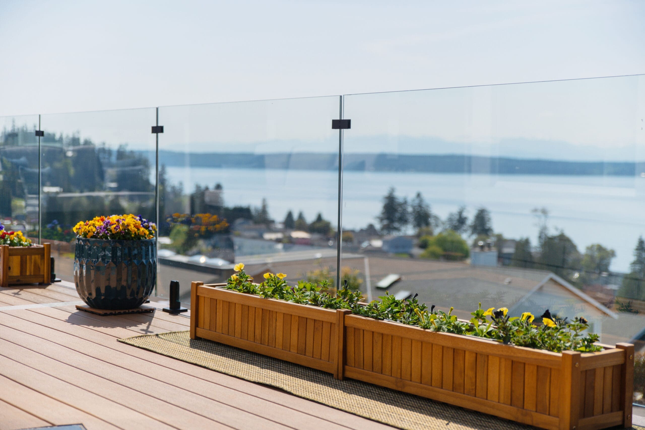 Balcony with flower planters overlooking scenic waterfront view