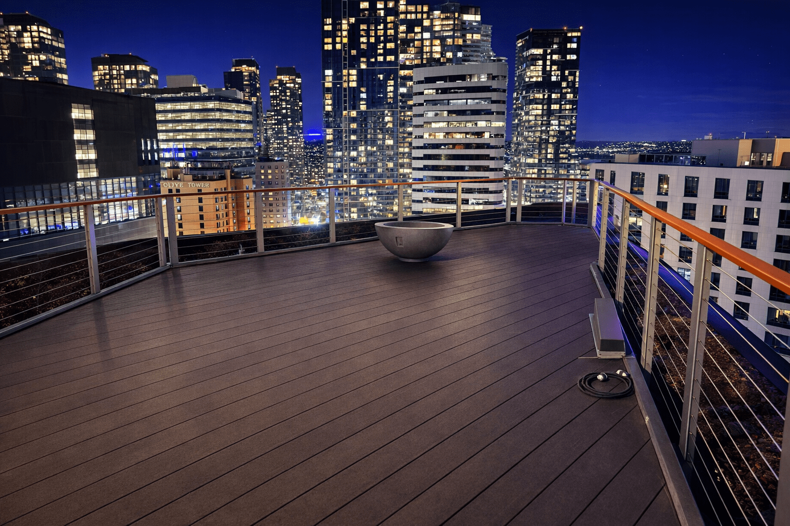 Rooftop terrace overlooking illuminated city skyline at night