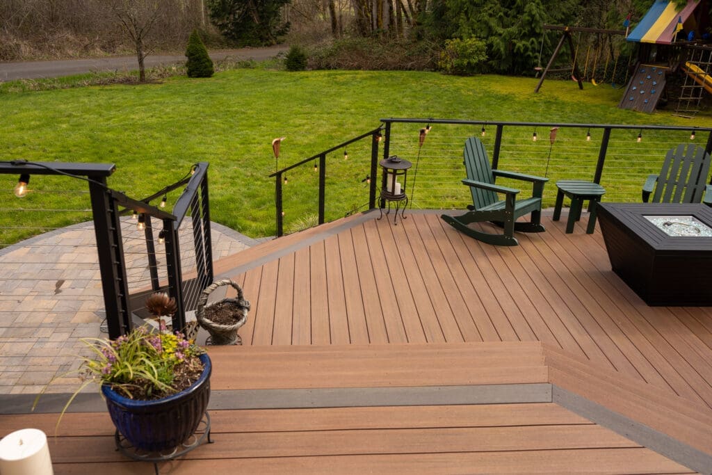 Backyard deck with chairs, fire pit, and lawn