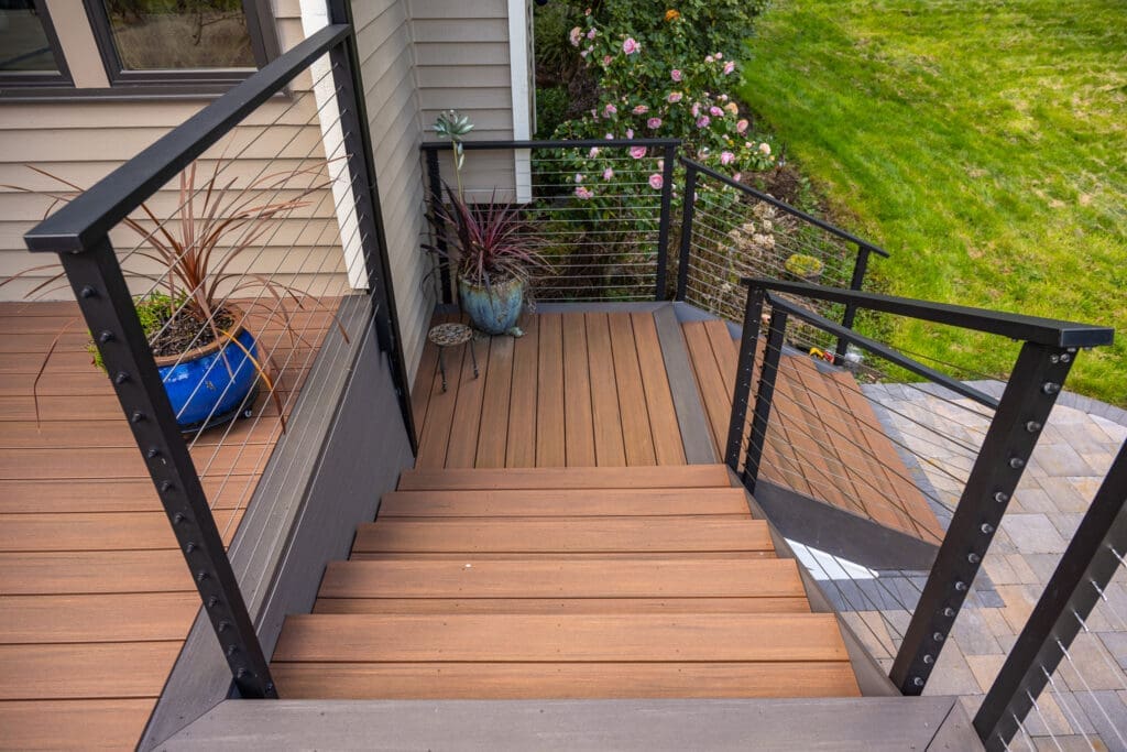 Modern wooden deck stairs with metal railing
