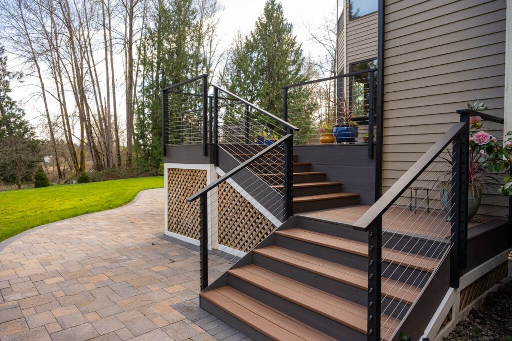 Modern deck stairs with cable railing and patio
