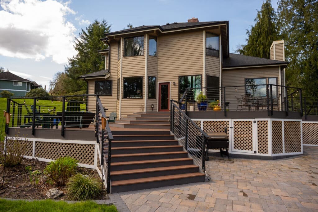 Two-story home with elevated backyard deck and stairs