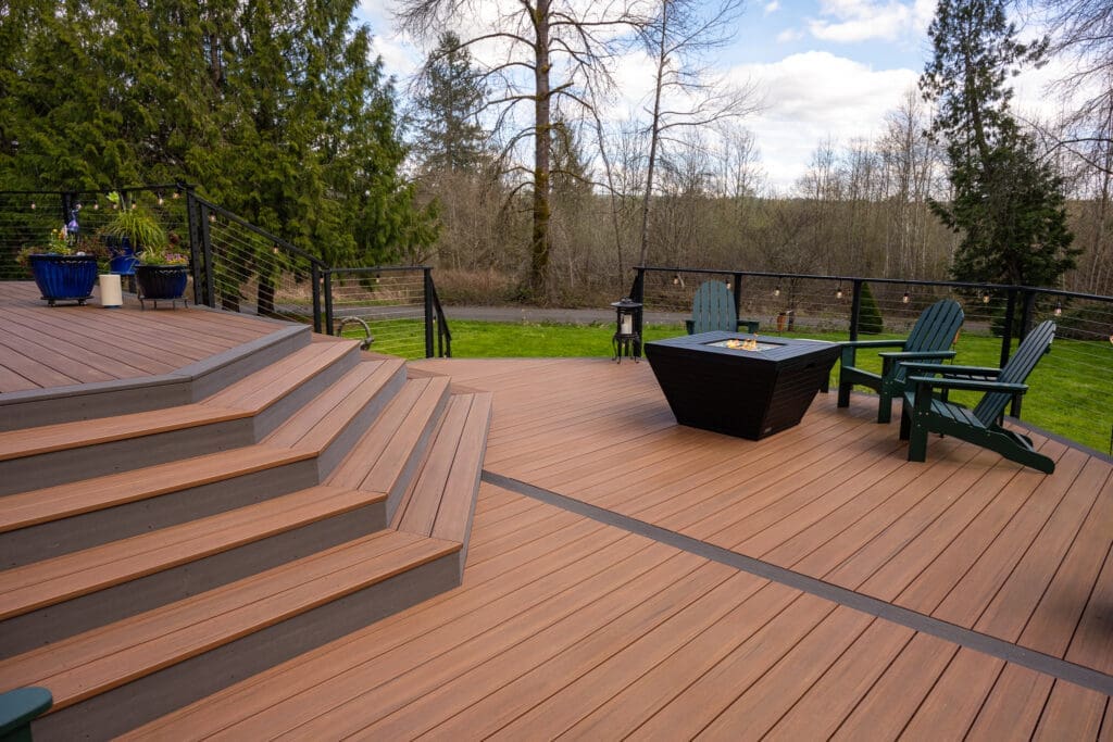 Spacious wooden deck with fire pit and chairs